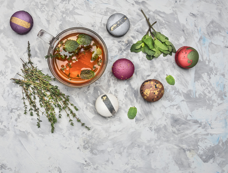 hot herbal tea with mint, cumin and fresh appetizing macaroons, on a white rustic background, top view, close upの写真素材