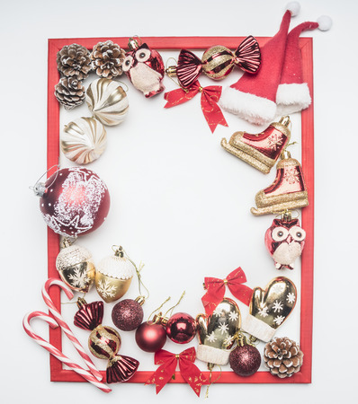 red frame made from Christmas toys, Christmas decorations, Christmas bells, on white background, top view, space for textの写真素材