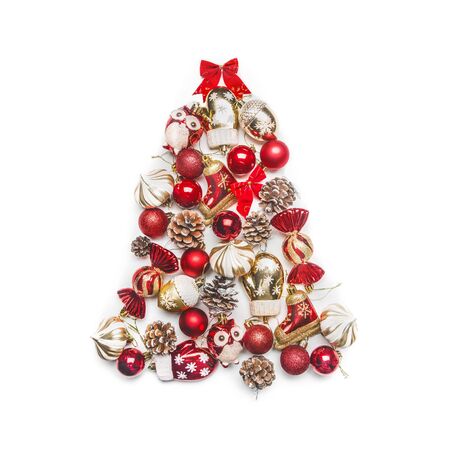 Christmas tree laid out of Christmas decorations and toys on a white background, top viewの写真素材