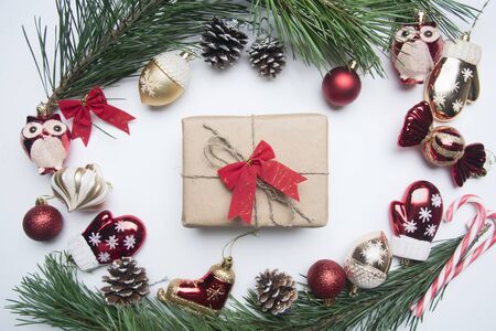 New Year or Christmas concept, various Christmas toys, a gift in wrapping paper, spruce branches, lined with a frame on a rustic wooden background, top viewの写真素材