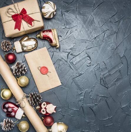 concept of Christmas gift wrapping, packing paper, toys and cones, on a dark rustic background, space for text, top viewの写真素材