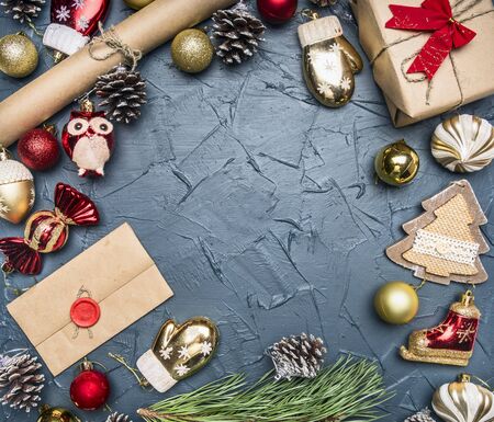 concept of Christmas gift wrapping, packing paper, toys and cones, on a dark rustic background, space for text, top viewの写真素材