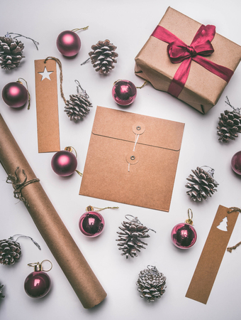 Christmas concept, postcard, gift box, Christmas toys and cones, on a white background, flat layの写真素材