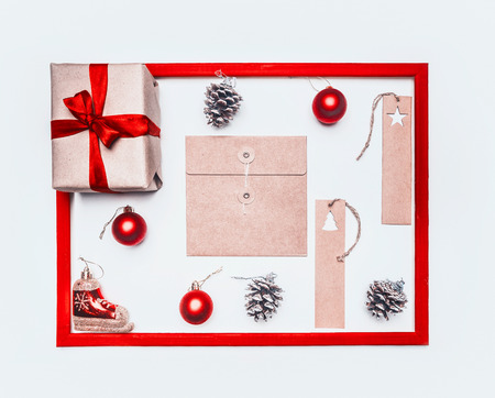 Christmas concept, greeting card, gift box, Christmas toys and cones, on a white background, frame flat layの写真素材