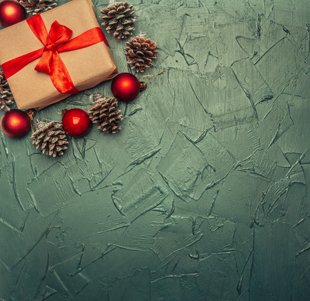 Christmas concept, greeting card, gift box, Christmas toys and cones, on a gray background, space for text flat layの写真素材