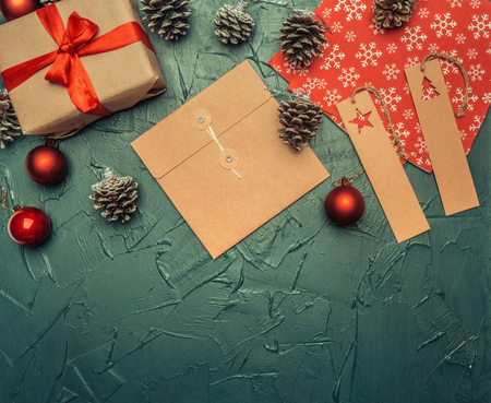 Christmas concept, greeting card, gift box, Christmas toys and cones, on a gray background, space for text flat layの写真素材