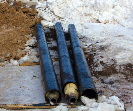 Three black damp-proof pipes on the snow