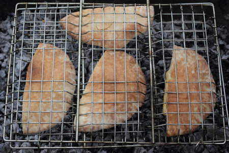 Arabic bread pita on the grill photoの写真素材