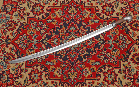 Circassian cavalry sword on the carpet photoの写真素材