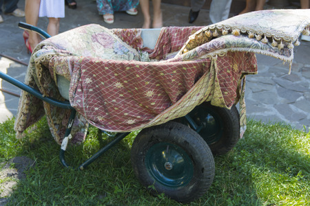 Wheelbarrow on the lawn near a private houseの写真素材