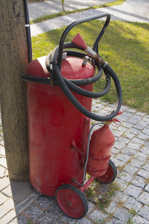 Fire extinguisher near a fire-dangerous objectの写真素材