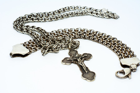 Bracelets, chains and crosses of silver on a white backgroundの写真素材