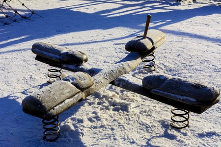 Children's swings and slides in the snow in the winterの写真素材