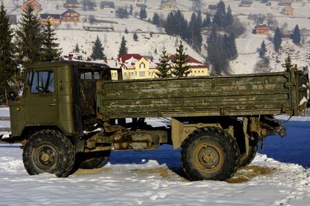 Old rusty machinery abandoned in the snow in the winterの写真素材