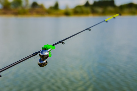 Lake in the mountains. Early morning. Fishing rod with a bellの写真素材