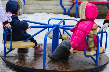 Children play on the playground in the winter on a holiday Maslenitsaの写真素材