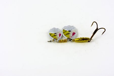 Bait for fishing in the shape of a spoon with a hook on a white backgroundの写真素材
