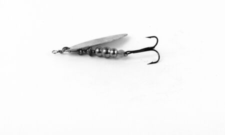Exhibition of pirated copies of fishing metal spoon baits. Bait for fishing in the shape of a spoon with a hook on a white background. 03/09/2017 Zhitomir.の写真素材