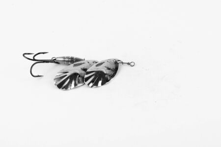 Exhibition of pirated copies of fishing metal spoon baits. Bait for fishing in the shape of a spoon with a hook on a white background. 03/09/2017 Zhitomir.の写真素材