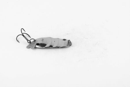 Exhibition of pirated copies of fishing metal spoon baits. Bait for fishing in the shape of a spoon with a hook on a white background. 03/09/2017 Zhitomir.の写真素材