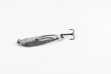 Exhibition of pirated copies of fishing metal spoon baits. Bait for fishing in the shape of a spoon with a hook on a white background. 03/09/2017 Zhitomir.の写真素材