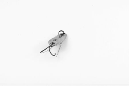 Exhibition of pirated copies of fishing metal spoon baits. Bait for fishing in the shape of a spoon with a hook on a white background. 03/09/2017 Zhitomir.の写真素材