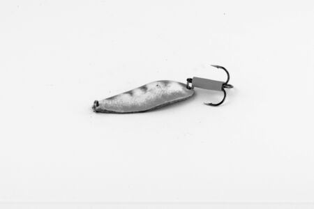 Exhibition of pirated copies of fishing metal spoon baits. Bait for fishing in the shape of a spoon with a hook on a white background. 03/09/2017 Zhitomir.の写真素材