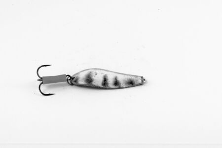 Exhibition of pirated copies of fishing metal spoon baits. Bait for fishing in the shape of a spoon with a hook on a white background. 03/09/2017 Zhitomir.の写真素材