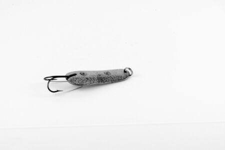 Exhibition of pirated copies of fishing metal spoon baits. Bait for fishing in the shape of a spoon with a hook on a white background. 03/09/2017 Zhitomir.の写真素材