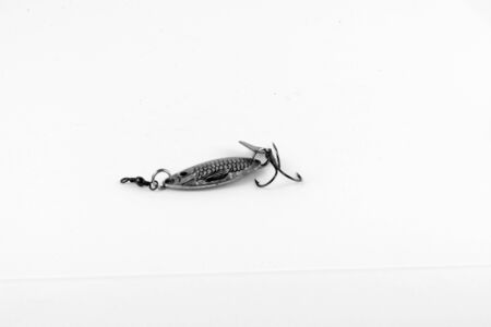 Exhibition of pirated copies of fishing metal spoon baits. Bait for fishing in the shape of a spoon with a hook on a white background. 03/09/2017 Zhitomir.の写真素材