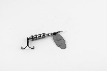 Exhibition of pirated copies of fishing metal spoon baits. Bait for fishing in the shape of a spoon with a hook on a white background. 03/09/2017 Zhitomir.の写真素材