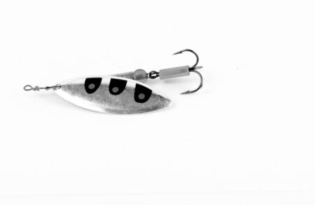 Exhibition of pirated copies of fishing metal spoon baits. Bait for fishing in the shape of a spoon with a hook on a white background. 03/09/2017 Zhitomir.の写真素材