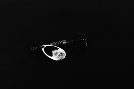 An exhibition of pirated copies of fishing metal spoon baits. Bait for fishing in the shape of a...