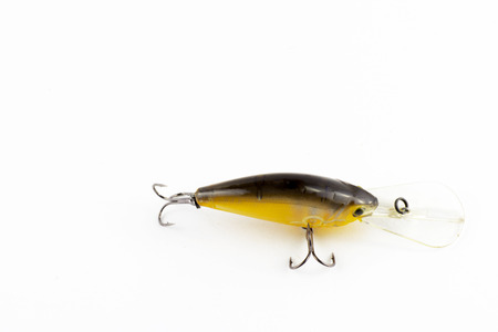 Exhibition of pirated copies of fishing metal spoon baits. Bait for fishing in the shape of a spoon with a hook on a white background.の写真素材