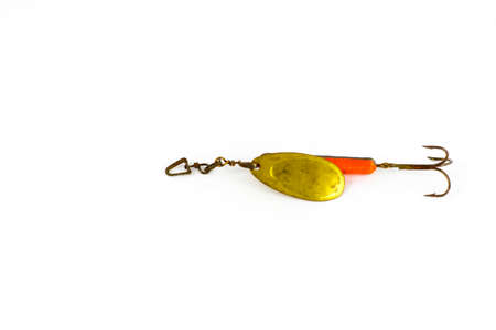 Exhibition of self-made fishing metal lures. Bait for fishing in the shape of a spoon with a hook on a white background.の写真素材