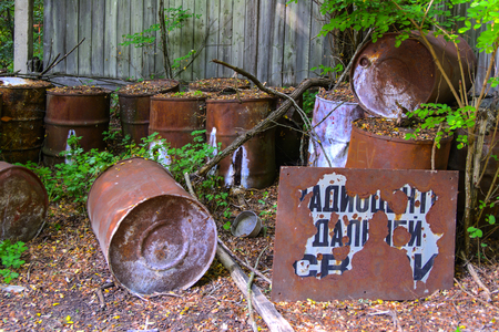 Old rusty barrels with radiation. Dead military unit. Consequences of the Chernobyl nuclear disaster, August 2017.のeditorial素材