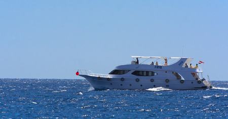 Sharm el-Sheikh, Egypt - March 14, 2018. Luxurious snow-white motor yacht in the Red Sea against the...
