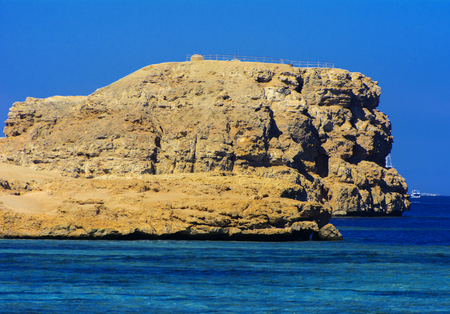 Elevated above sea level, beautiful coral reefs the form mountains and rocks against the blue sky and clear sea water coast of the unique Ras Mohammed nature reserve. Magnificent diving, summer, rest.の写真素材