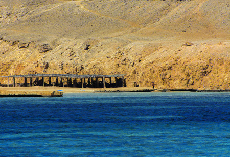 Elevated above sea level, beautiful coral reefs the form mountains and rocks against the blue sky and clear sea water coast of the unique Ras Mohammed nature reserve. Magnificent diving, summer, rest.の写真素材