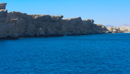 Elevated above sea level, beautiful coral reefs the form mountains and rocks against the blue sky...