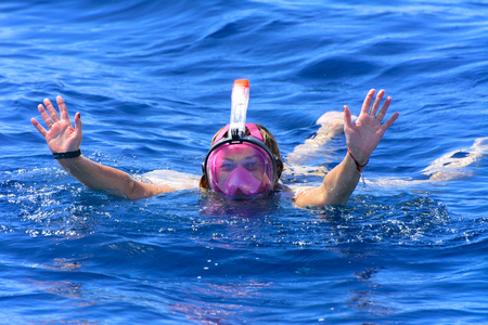 Sharm el-Sheikh, Egypt - March 14, 2018. Tourists swim in the transparent turquoise sea and see beautiful colorful fish on the background of corals in the Red Sea. Relaxation during rest. Egypt.のeditorial素材