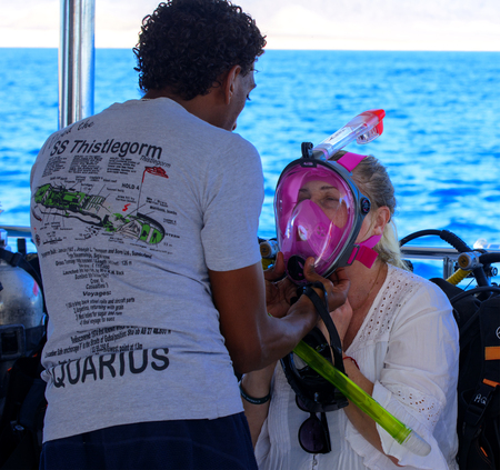 Sharm el-Sheikh, Egypt - March 14, 2018. A portrait of an African diving instructor instructs people on the yacht on the background of clear water, immersion and extreme sports concepts.のeditorial素材