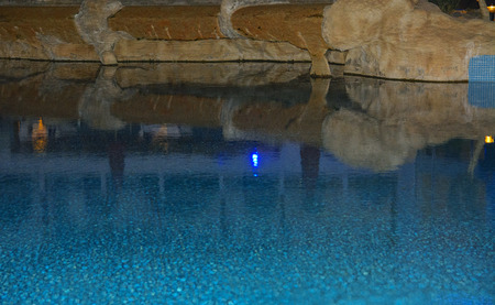 Sharm el-Sheikh, Egypt - March 14, 2018. Beautiful pool with clear blue water and reflection of objects in it at night. Cyrene Grand Hotel.のeditorial素材