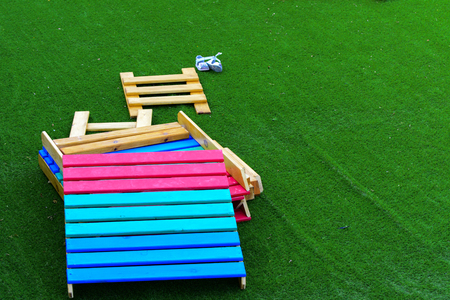 Children's wooden multi-colored game constructions on a background of green artificial grass.の写真素材
