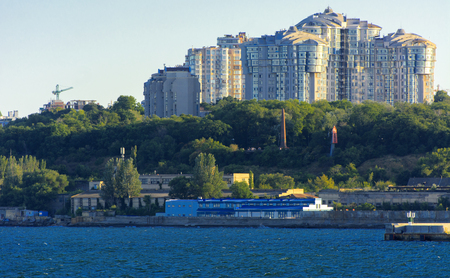 Magnificent panorama, view from the sea to the coastal strip of the city before sunset in the soft sunlight. High-rise buildings and commercial facilities on the shoreの写真素材