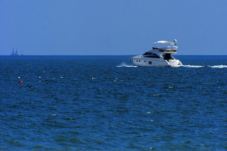 Ship for walks in open sea in evening soft sunlight against a blue sky. The concept of summer adventures, holidays, active summer holidays on the Black Sea, Ukraineの写真素材