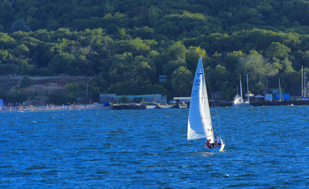 Odessa, Ukraine - August 08, 2018. Gorgeous sailboat on open sea in evening soft sunlight against a blue sky. Concept of summer adventures, holidays, active summer holidays on the Black Sea, Ukraineのeditorial素材