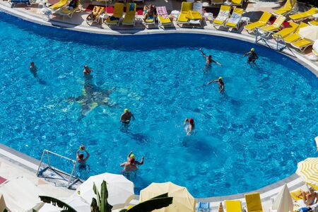 Alanya, Turkey - October 05, 2018. A group of people plays water polo in the blue clear water of the...