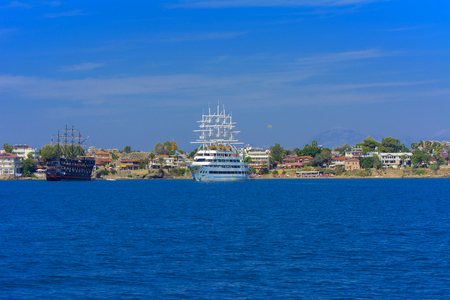 Alanya, Turkey - October 05, 2018. A large sailing ship in a pirate style is moored near the coast against a blue sky. Photos of the ship from the sea. The concept of summer holidays, sports, tourismのeditorial素材