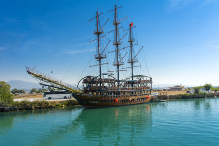 Alanya, Turkey - October 05, 2018. A large sailing ship in a pirate style is moored near the coast against a blue sky. Photos of the ship from the sea. The concept of summer holidays, sports, tourismのeditorial素材